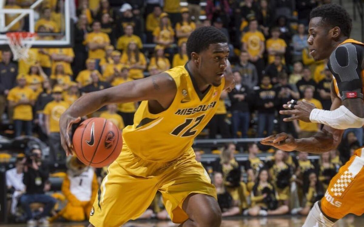 Missouri's Namon Wright (left) drives toward the basket as Tennessee's Devon Baulkman defends during their Feb. 13 SEC basketball game at Mizzou Arena. The Tigers won the game 75-64.