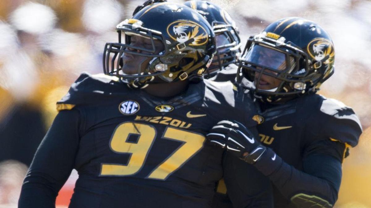 
Missouri Tigers defensive lineman Josh Augusta (center) celebrated an interception with Missouri Tigers defensive back Aarion Penton during a game last year.
