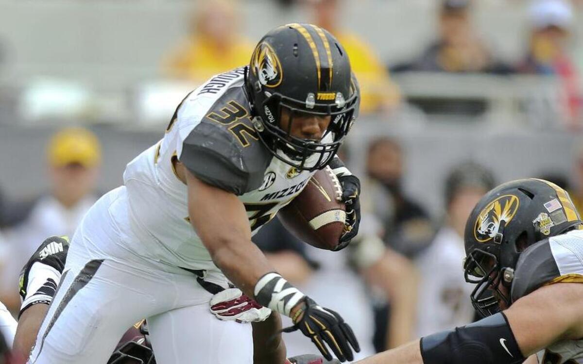
Missouri tailback Russell Hansbrough, shown here running against Minnesota defenders during the Citrus Bowl Jan. 1 in Orlando, Fla., was elected one of four Tiger football captains Thursday. The others are Evan Boehm Ian Simon and Kenya Dennis. 
