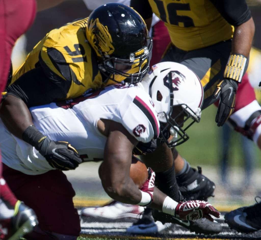 The Tigers’ Charles Harris (left) is one of 158 players in preliminary contention for the Rotary Lombardi Award.
