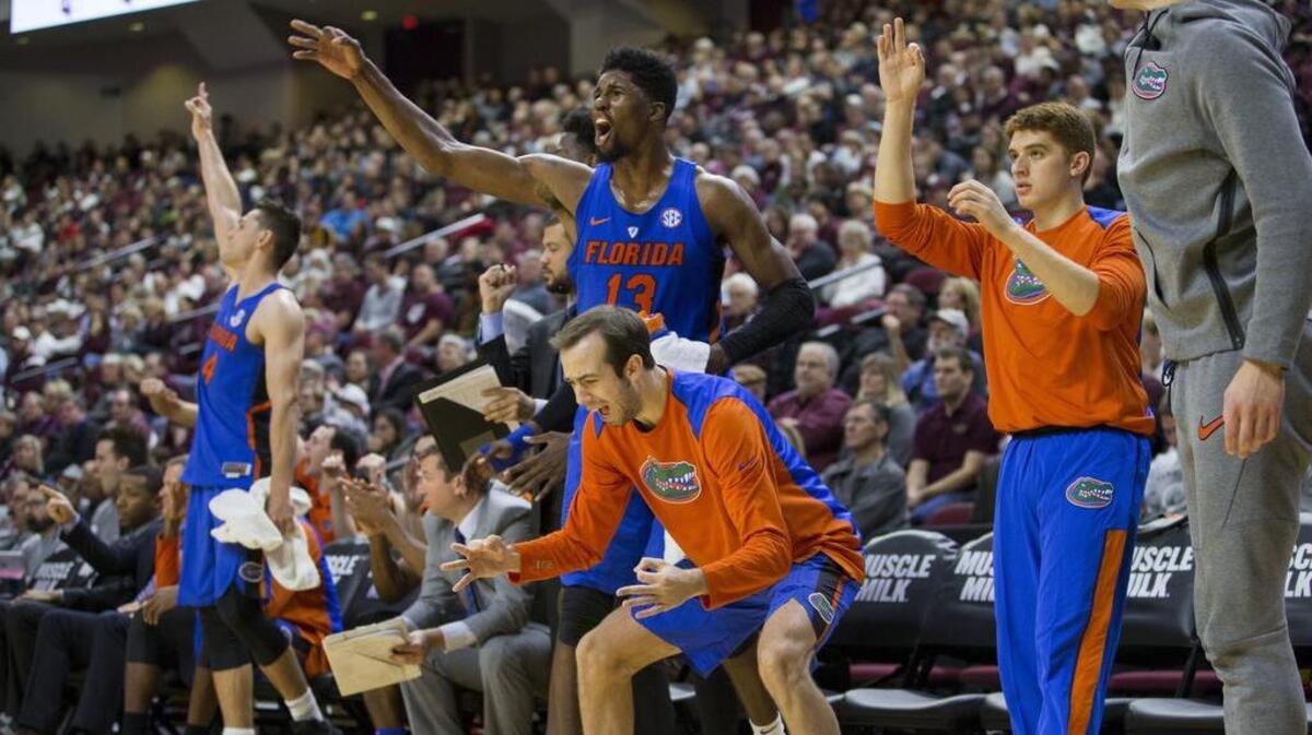 Members of the Florida Gators bench react after a teammate hit a three pointer against Texas A&M during the second half of an NCAA college basketball game Tuesday, Jan. 2, 2018, in College Station, Texas. Florida won, 83-66.