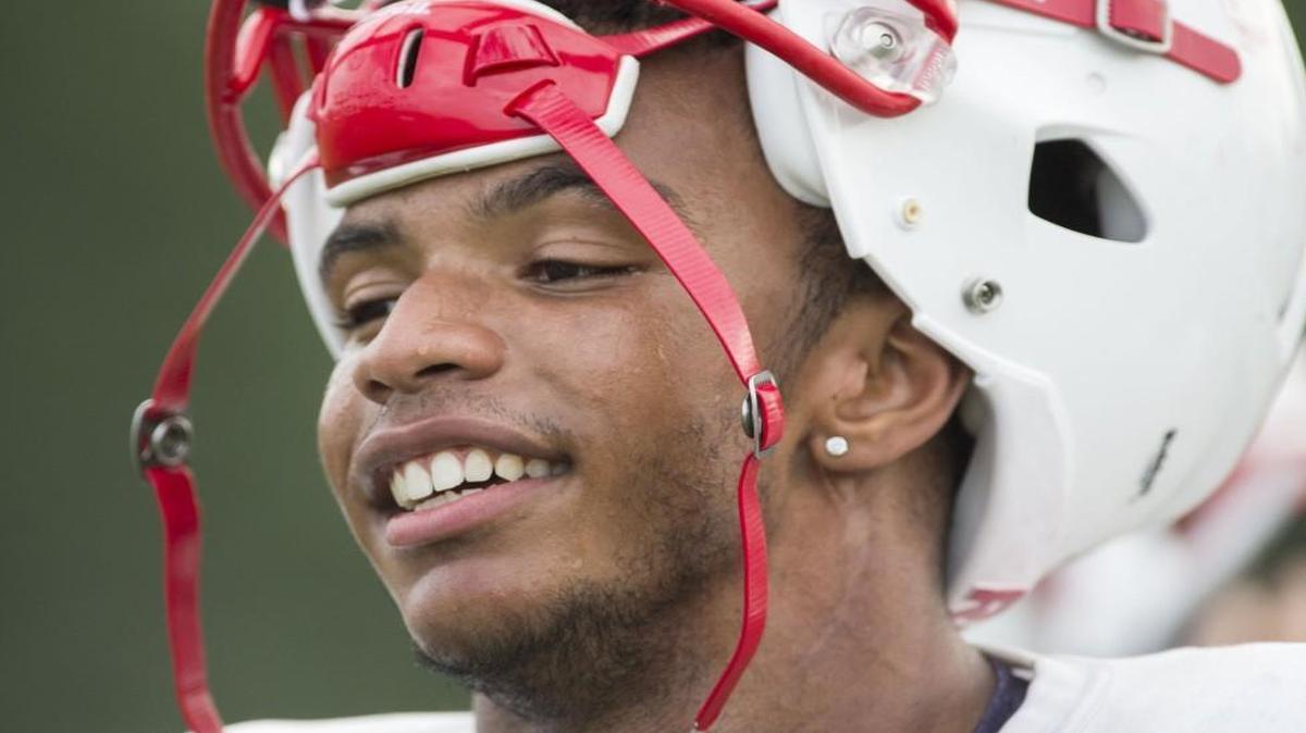 Josh Moore smiled during a break at football practice while he was at Olathe North High School.