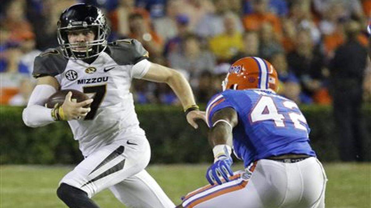 
Missouri quarterback Maty Mauk, here being forced out of the pocket by Florida defensive back Keanu Neal, had only 20 passing yards on Saturday in Gainesville, Fla.
