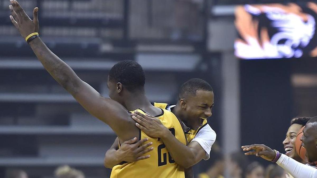 Missouri big man Jeremiah Tilmon was mobbed by teammates after sinking a half-court shot during the “Hot Shot” contest during Mizzou Madness festivities Saturday at Mizzou Arena.