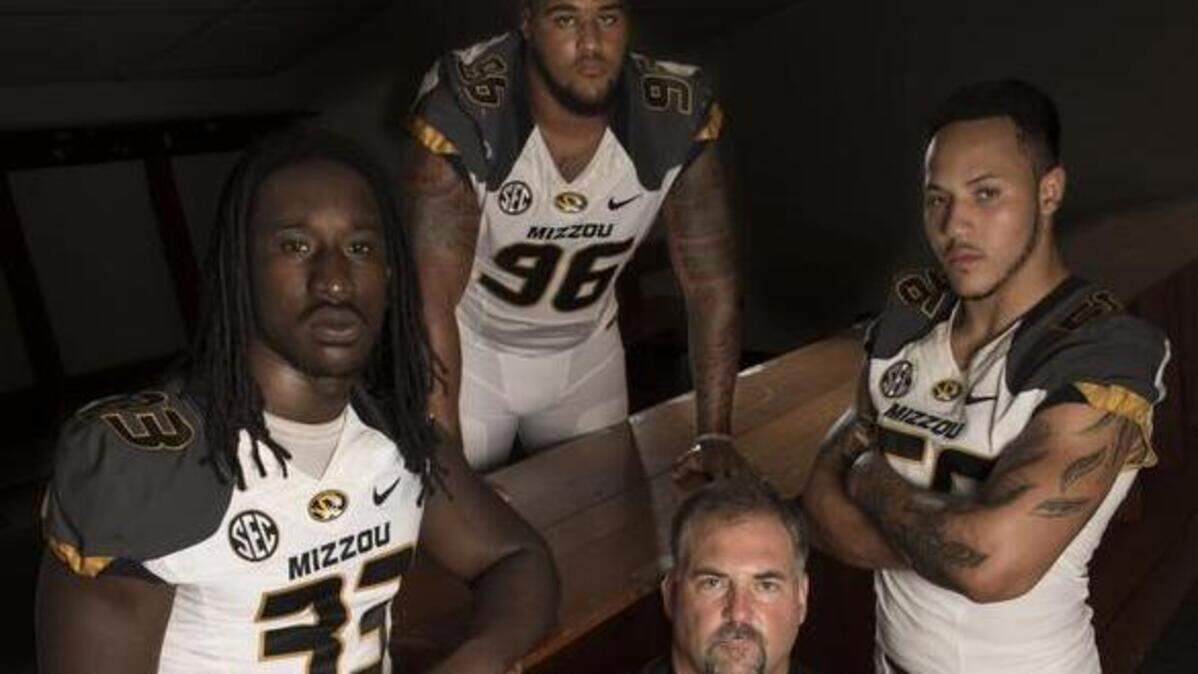 Craig Kuligowski (bottom), then Mizzou’s defensive line coach, was surrounded by players Markus Golden (left), Lucas Vincent, and Shane Ray during a 2015 photo shoot.