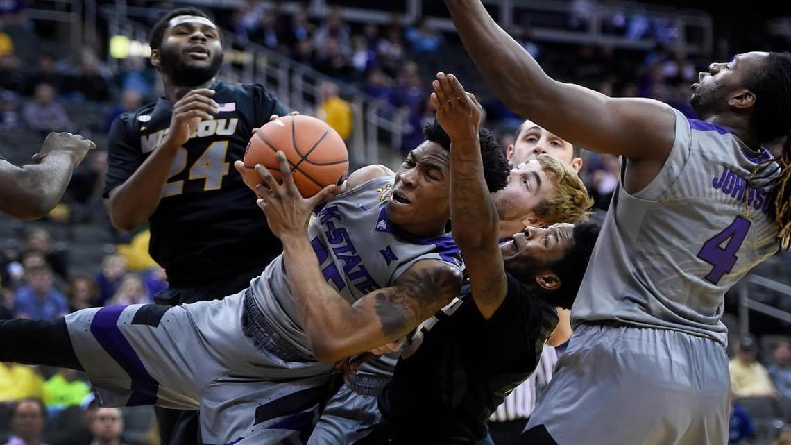 Kansas State’s Wesley Iwundu grabbed a rebound away from Missouri’s Kevin Puryear (left), Wes Clark (middle) and teammate D.J. Johnson in the first half of their CBE Classic semifinal game Monday night at the Sprint Center. The Wildcats won 66-42.