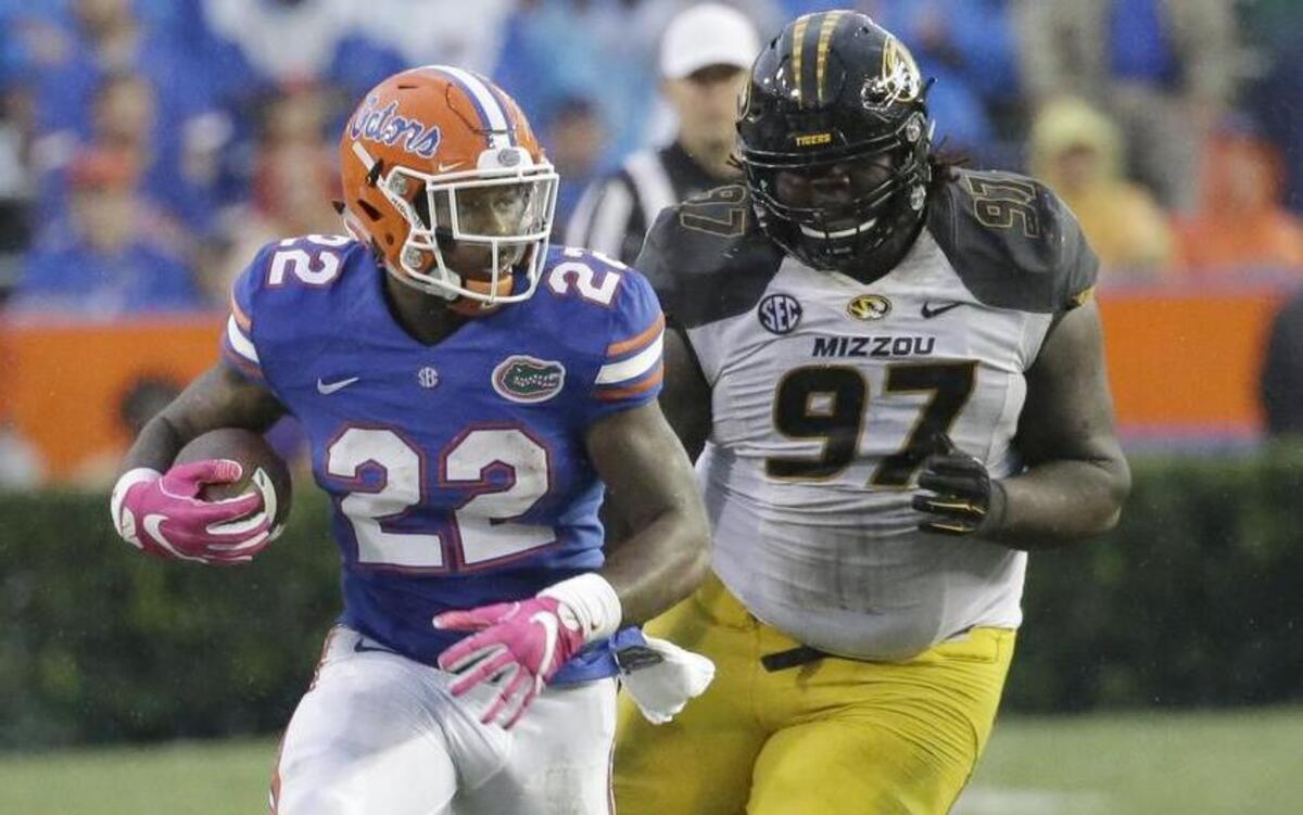 Florida’s Lamical Perine (left) gets by Josh Augusta of Missouri in the second half of Saturday’s game in Gainesville, Fla.