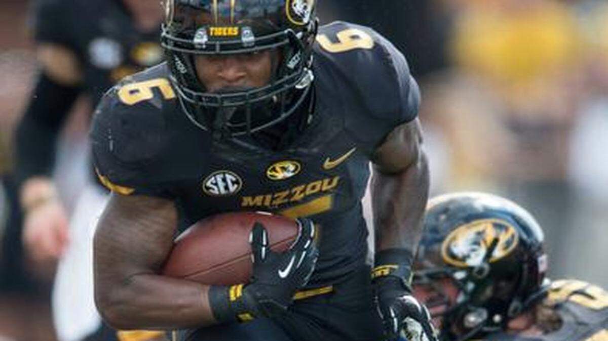 
Missouri running back Marcus Murphy (6) ran through the tackle attempt by South Dakota State free safety Nick Mears in the second quarter Saturday in Columbia.
