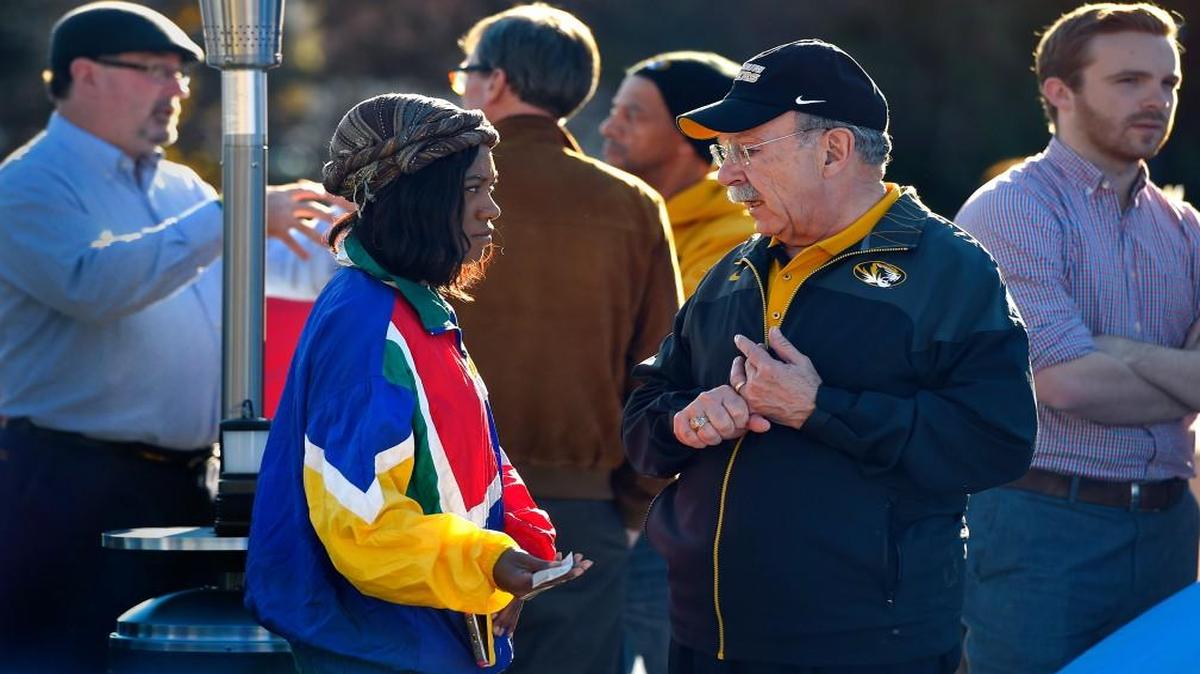 University of Missouri Chancellor R. Bowen Loftin (second from right) spoke with people Sunday at the location where student protesters have put up tents on the campus as part of an effort to oust MU System President Tim Wolfe.