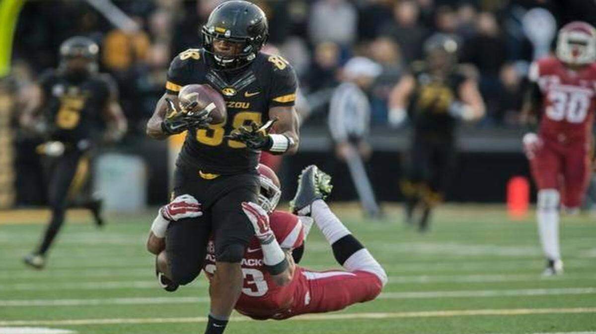 
Missouri wide receiver Jimmie Hunt (88) caught a pass as Arkansas cornerback Tevin Mitchel dove for the tackle during their Nov. 28 game at Faurot Field in Columbia. The Tigers beat the Razorbacks 21-14 to claim their second consecutive SEC East Division Championship.
