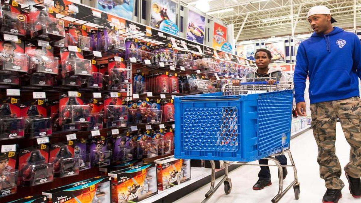 E.J. Gaines of the St. Louis Rams and Malachi Acklin shopped for toys Tuesday at Toys R Us in Independence. Gaines, who played football at Fort Osage High School and the University of Missouri, gave 15 youngsters from the Hope Center $100 gift cards to use at the store.