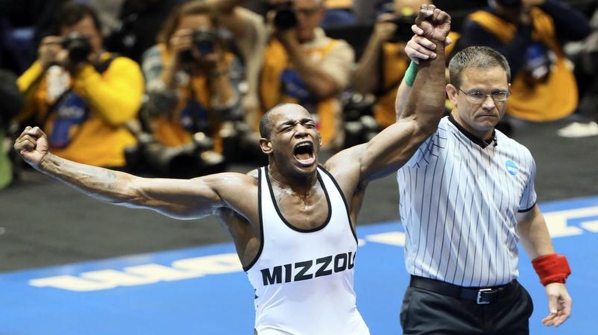 J’den Cox (left) won three national championships in four years as a wrestler for Mizzou. His most recent title came in March in St. Louis.