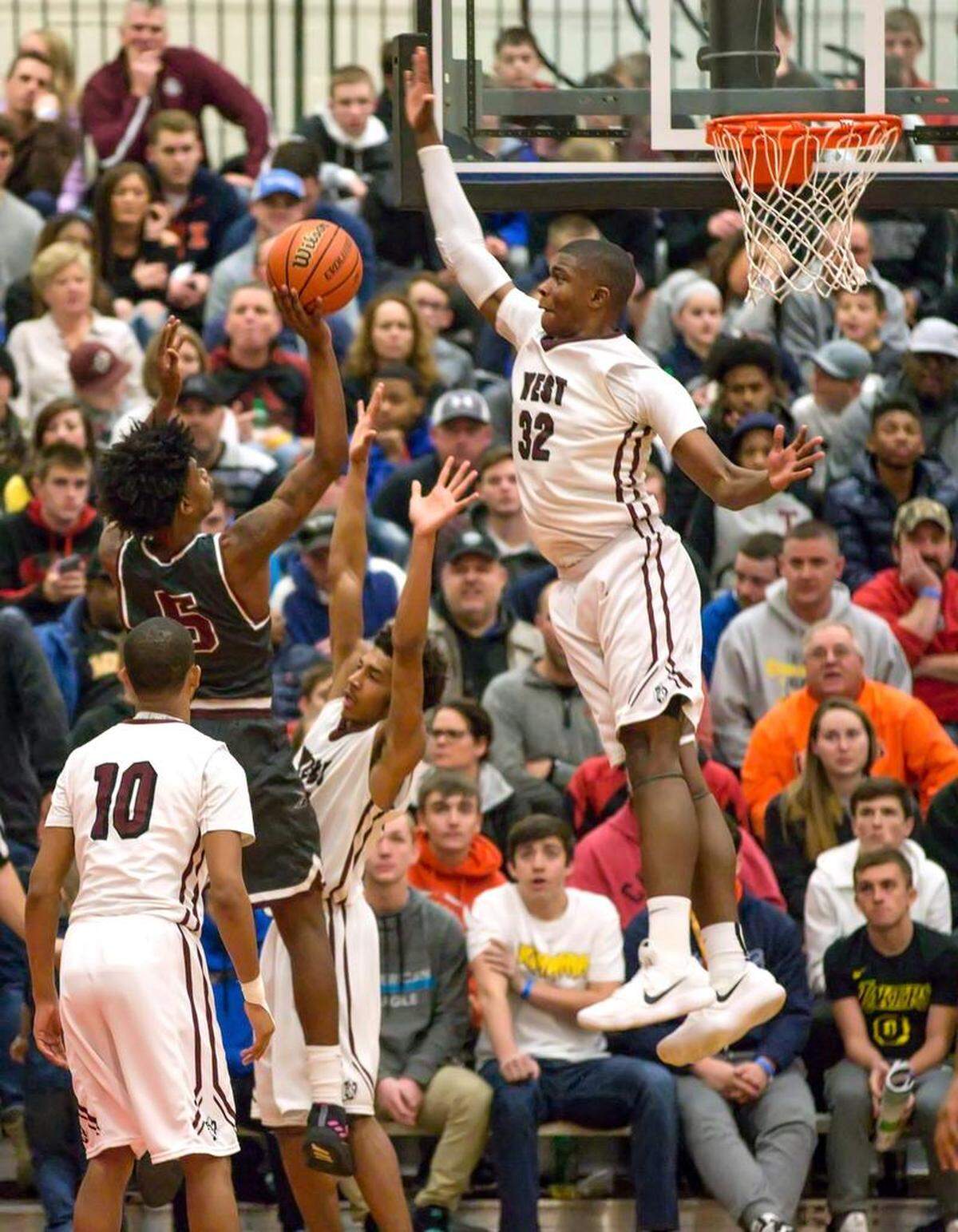 Belleville West EJ Liddell blocks Poplar Bluff Rodney Houston shot during Saturdays 27th Annual Highland Shootout at Highland High School. 