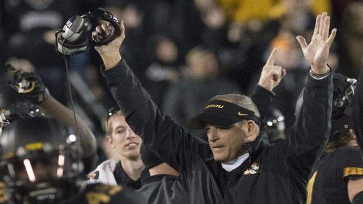 
Missouri Tigers head coach Gary Pinkel and the rest of the team celebrated when a ruling on the field was reversed, giving Missouri Tigers defensive lineman Markus Golden (not pictured) a fumble recovery and the Missouri offense the ball late in the fourth quarter against Arkansas on Nov. 28 at Faurot Field in Columbia. Missouri beat Arkansas 21-14, claiming their second consecutive SEC East Division Championship.

