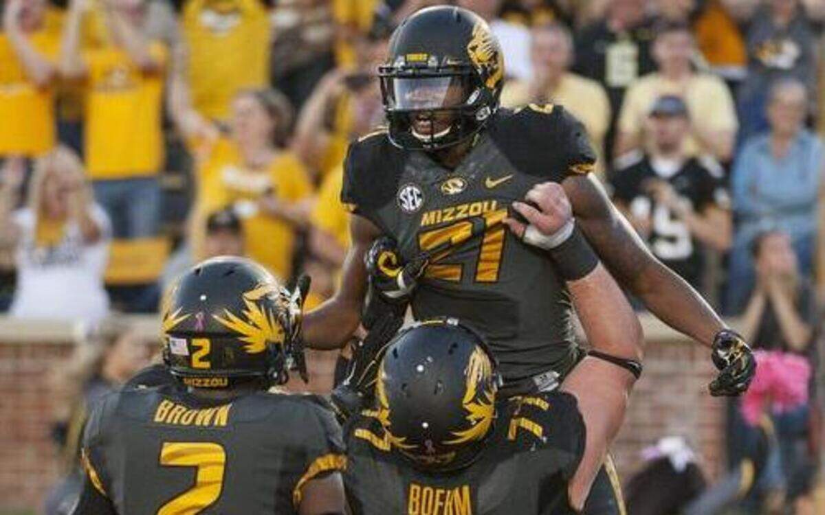
Missouri wide receiver Bud Sasser (top) was hoisted by teammate Evan Boehm as Nate Brown (left) also celebrated Sasser’s touchdown against Vanderbilt on Oct. 25 in Columbia. Missouri won the game 24-14.

