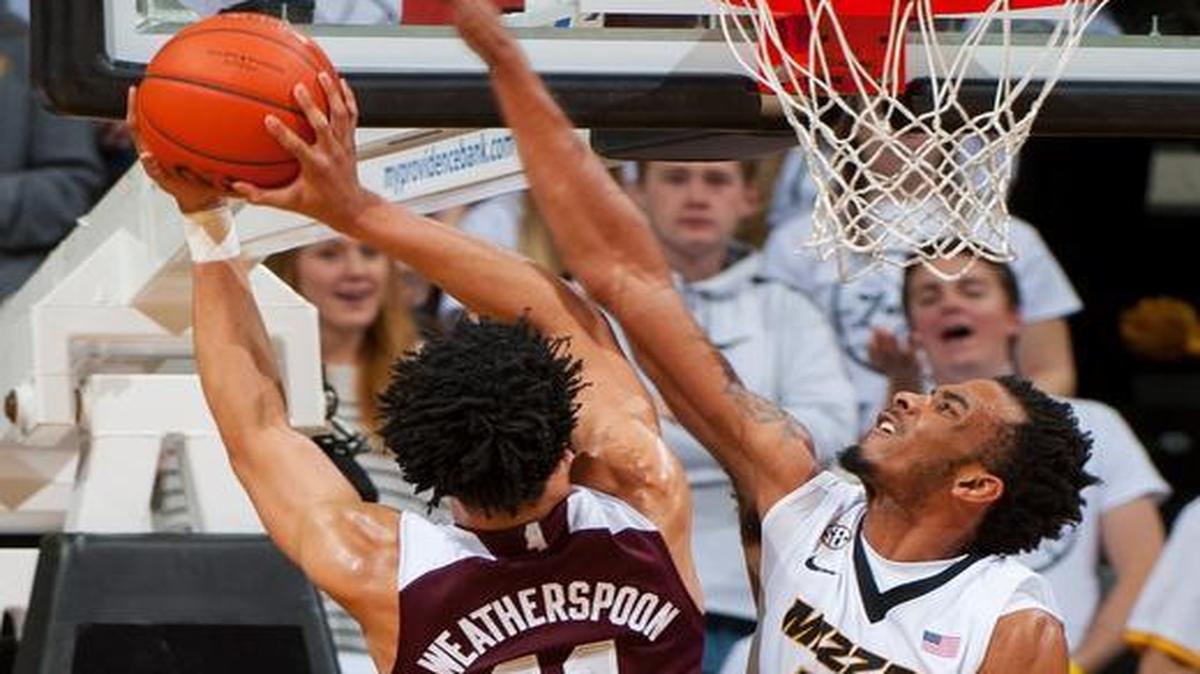 Missouri’s Jakeenan Gant (right) blocked the shot of Mississippi State’s Quinndary Weatherspoon in the first half as the Tigers and Bulldogs played Saturday night at Mizzou Arena in Columbia.