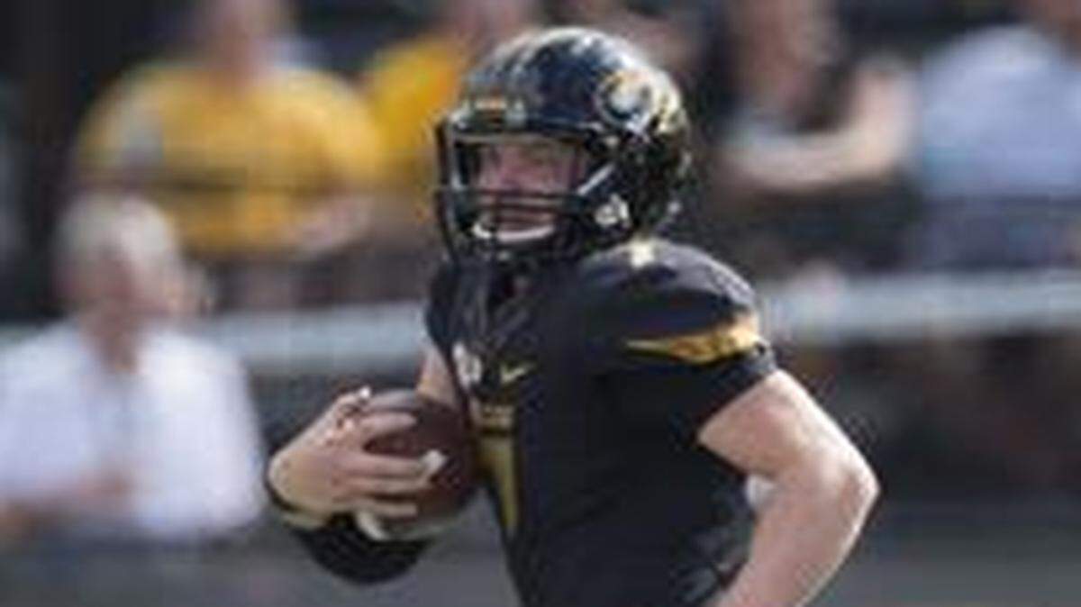 
South Dakota State Jackrabbits defensive back Jimmie Forsythe (25) and linebacker Austin Benson (51) tried to run down Missouri Tigers quarterback Maty Mauk (7) in the second quarter Saturday at Faurot Field.
