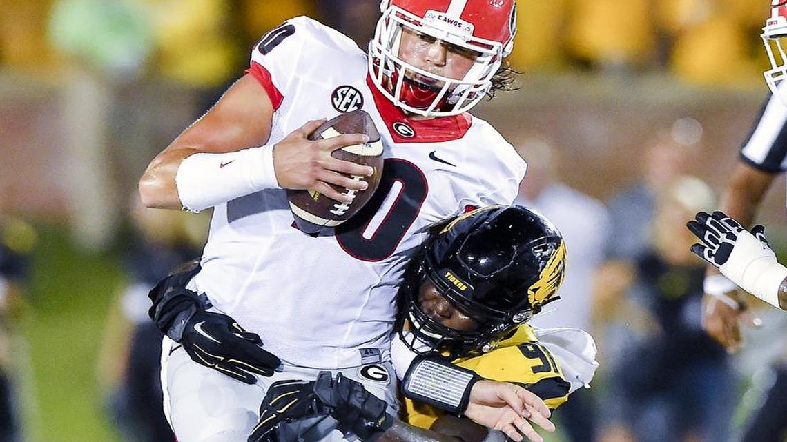 Missouri Tigers defensive end Charles Harris (right) sacked Georgia Bulldogs quarterback Jacob Eason during the first half Sept. 17 in Columbia.
