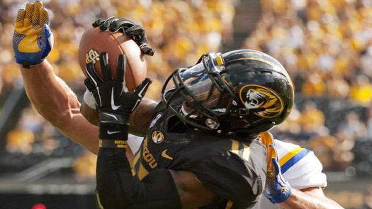
Missouri’s Aarion Penton intercepted a pass in front of South Dakota State’s Jason Schneider last Saturday.
