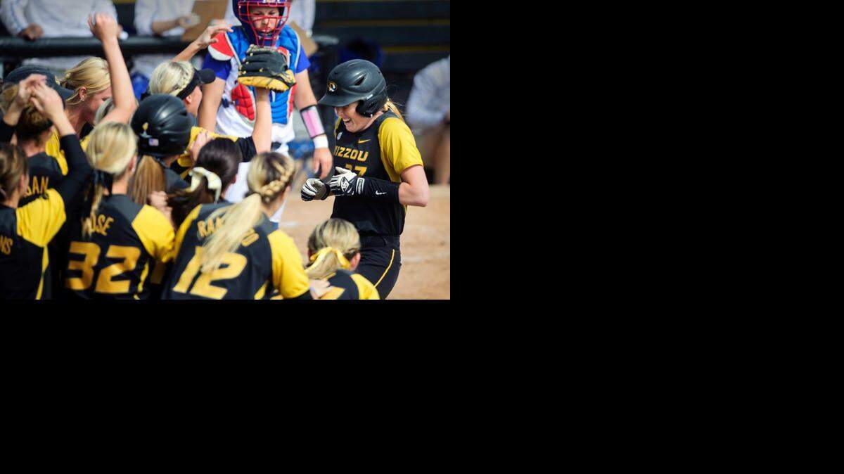 MU’s Kirsten Mack (right) was greeted by teammates at home plate after hitting a home run against Kansas.<252><137>Missouri's Kirsten Mack (27) is greeted by teammates at home plate after hitting a home run against Kansas in an NCAA softball tournament regional in Columbia, Mo., on Saturday, May 17, 2014. (AP Photo/Columbia Daily Tribune, Ryan Henriksen)<252><137>