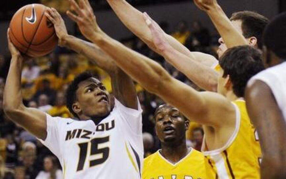 
Missouri’s Wes Clark (left) shot over several Valparaiso defenders in the first half Sunday in Columbia. The Tigers beat the Crusaders 56-41, Kim Anderson’s first regular-season win as coach of Missouri.
