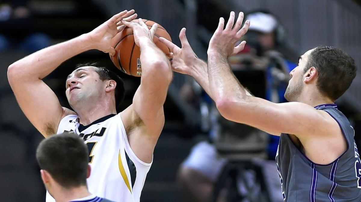Missouri senior center Ryan Rosburg (left) responded to his first start with season highs of eight points and nine rebounds Tuesday against Northwestern in the CBE Hall of Fame Classic third-place game at the Sprint Center. On this play, Rosburg had the ball knocked out of his hands by Northwestern’s Alek Olah.