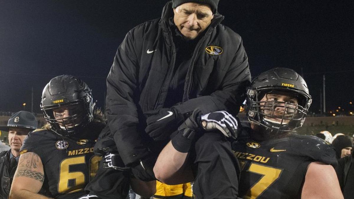 Connor McGovern (left) and Evan Boehm carried MU head coach Gary Pinkel off the field Saturday following Pinkel’s final home game before retirement. McGovern, Boehm and Kentrell Brothers have accepted Senior Bowl invites.