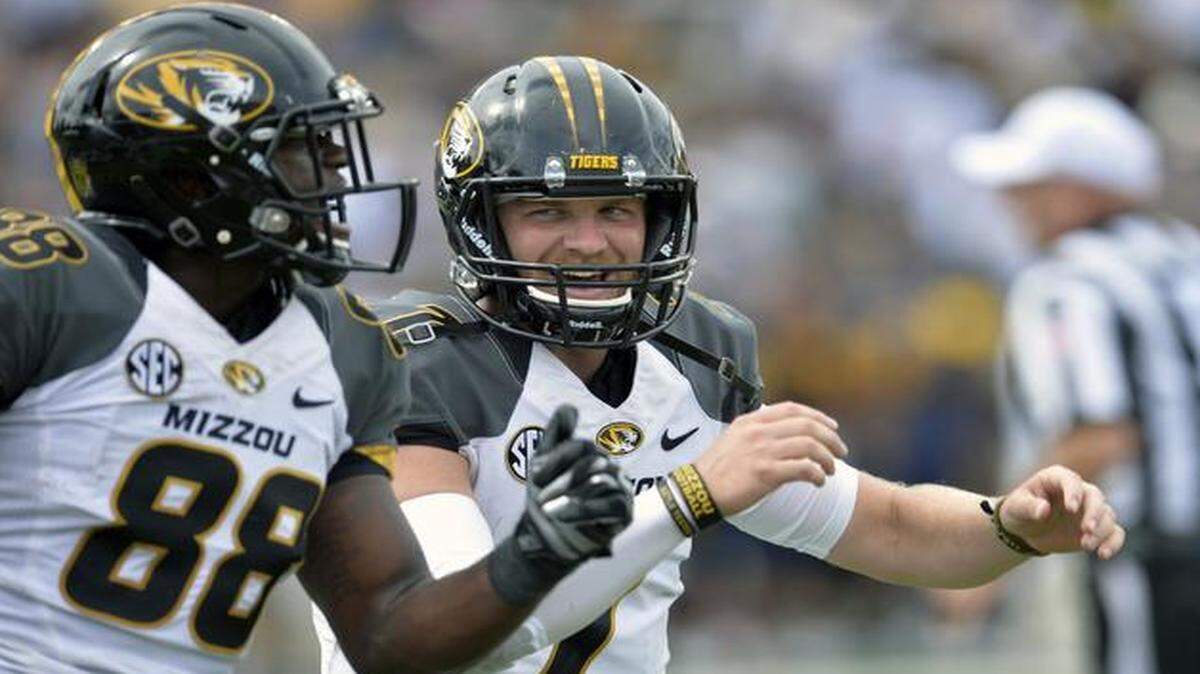 
Missouri quarterback Maty Mauk (right) celebrated his touchdown pass to wide receiver Jimmie Hunt (left) against Toledo.
