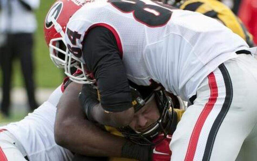 
Missouri quarterback Maty Mauk was sacked by Georgia’s Leonard Floyd (right) in second quarter of Saturday’s game.
