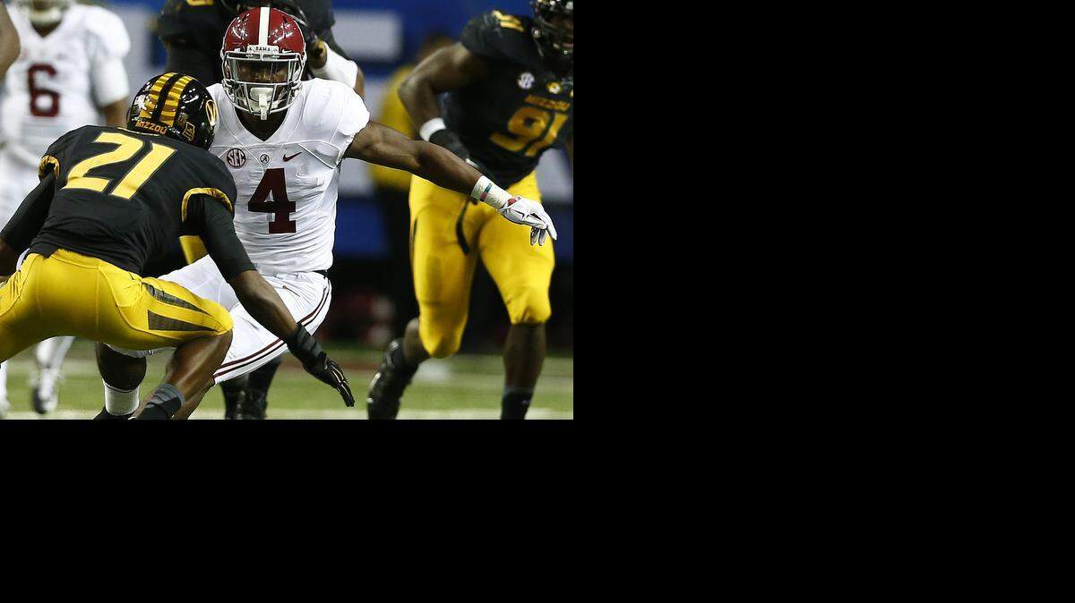 Alabama running back T.J. Yeldon (4) runs toward Missouri safety Ian Simon (21) during the first half of the Southeastern Conference championship NCAA college football game, Saturday, Dec. 6, 2014, in Atlanta.
