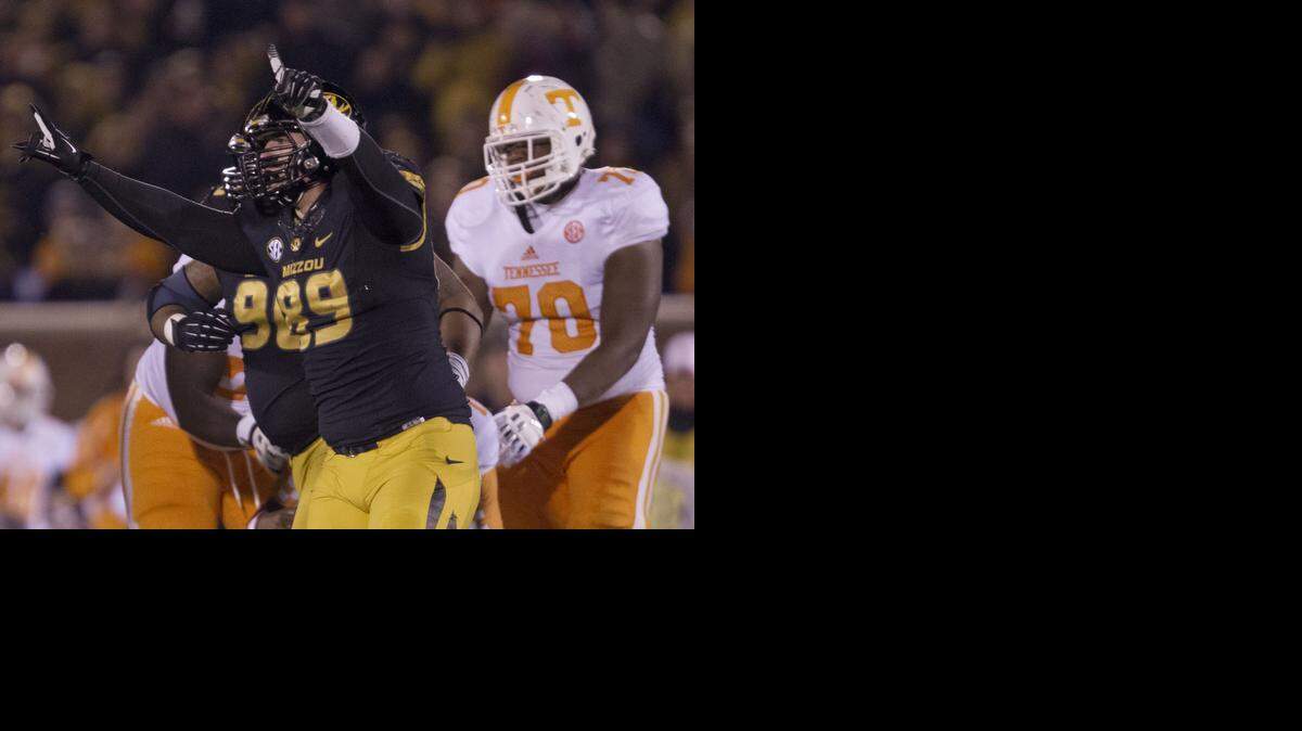 
Missouri Tigers defensive lineman Matt Hoch (left) celebrated after sacking Tennessee quarterback Joshua Dobbs as Volunteers offensive linesman Ja'Wuan James watched in the second half of last year’s Mizzou-Vols game in Columbia. Missouri beat Tennessee 31-3.
