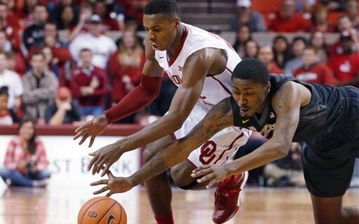 
Oklahoma guard Buddy Hield (left) and Missouri forward D'Angelo Allen reach for the ball during Friday’s game in Norman.
