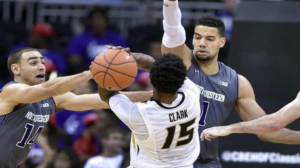 Missouri’s Wes Clark was stopped in his tracks by Northwestern’s Tre Demps (from left) Joey Van Zegren and Bryant McIntosh at the CBE Hall of Fame Classic at the Sprint Center.