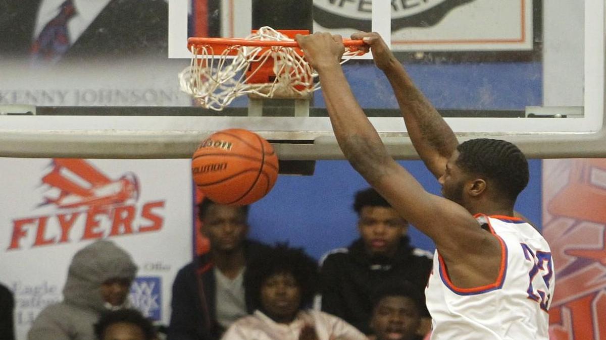 East St. Louis player Jeremiah Tilmon dunked the ball in the opening minutes of the game against visiting Belleville East.