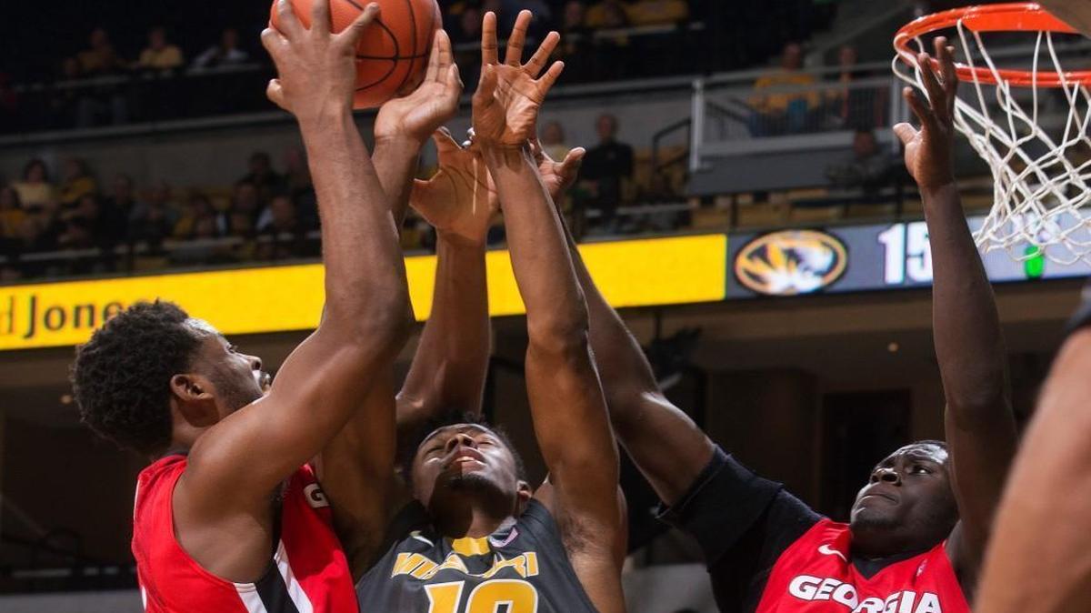 Georgia’s Yante Maten (left) and Derek Ogbeide fought off Missouri’s K.J. Walton (center) as they battled for a rebound in the first half as the Bulldogs and Tiger played Wednesday night at Mizzou Arena in Columbia.