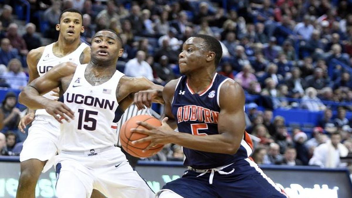 Auburn’s Mustapha Heron (5) drives past Connecticut’s Rodney Purvis (15) in Hartford, Conn., on Dec. 23, 2016. Auburn won the game against Connecticut in overtime 70-67.