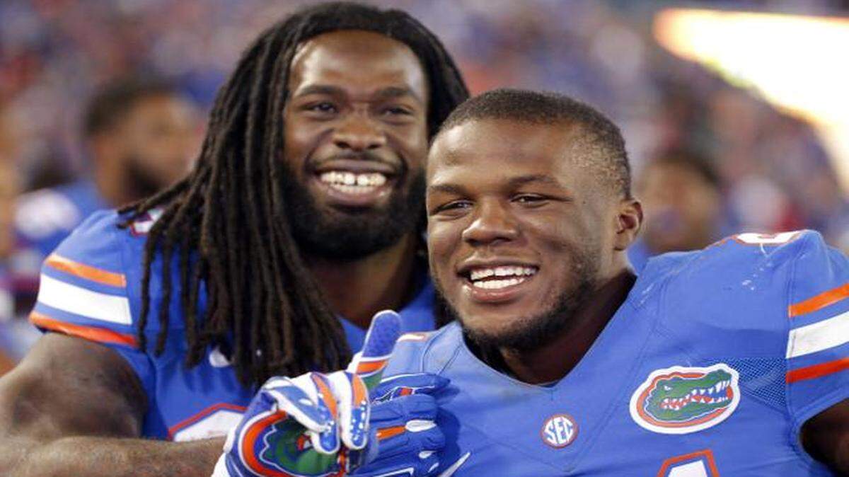 
Florida running back Kelvin Taylor, right, and Florida running back Matt Jones, left, celebrate on the sidelines during the second half of an NCAA college football game in Jacksonville, Fla., Saturday, Nov. 1, 2014. Florida beat Georgia 38-20. 
