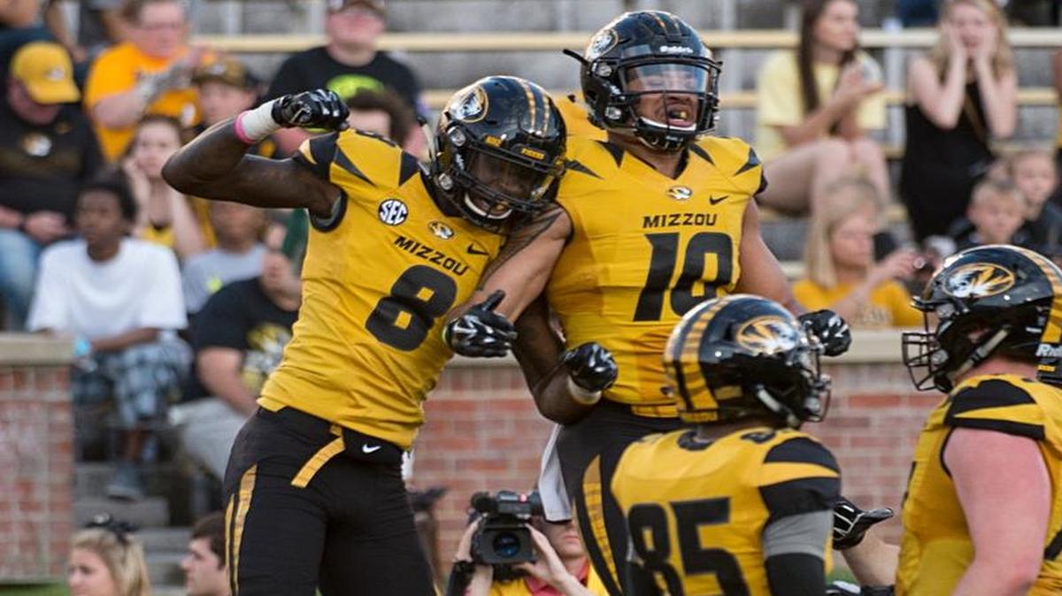 MU’s Justin Smith (left) and Jason Reese leaped into the air to celebrate Smith’s touchdown in Saturday’s spring game.