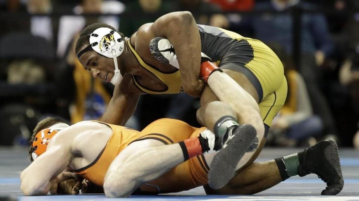 Missouri wrestler J’den Cox (right) won his second college national championship this spring.