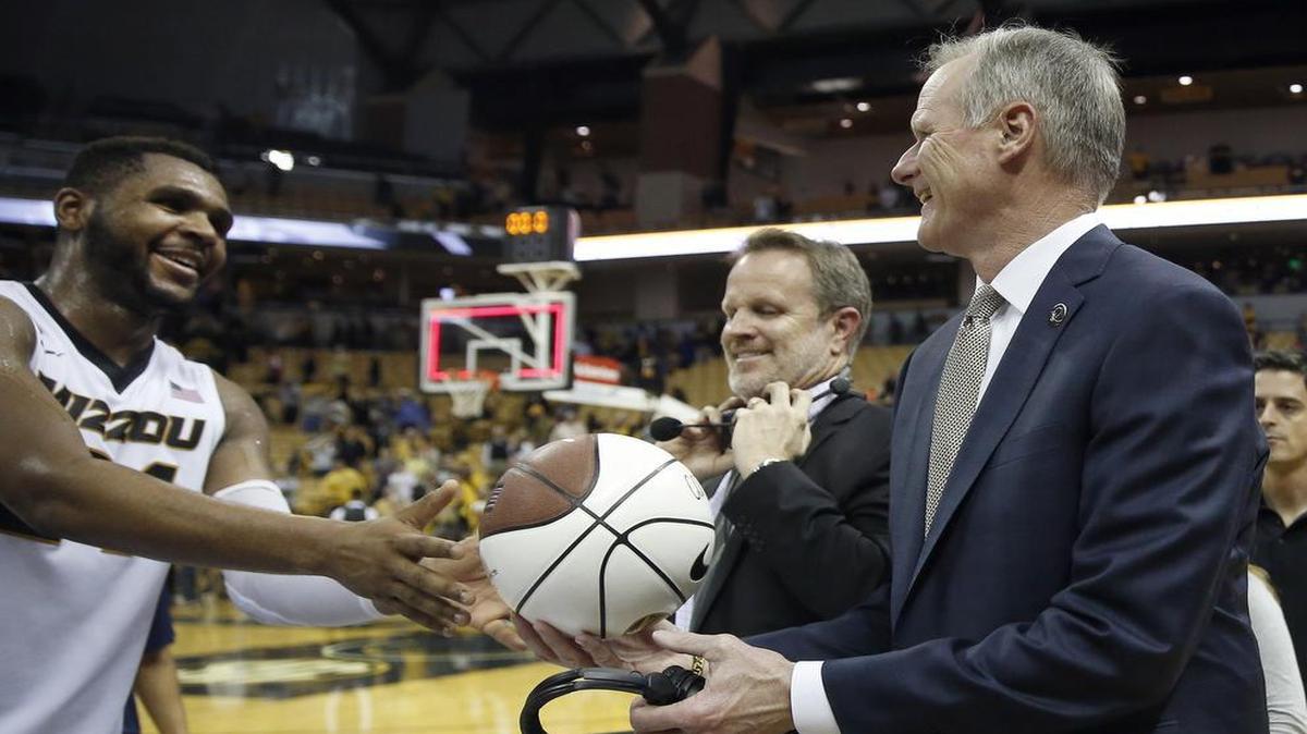 Missouri head coach Kim Anderson (right) was handed the game ball by Kevin Puryear on Saturday after Anderson picked up his 300th victory as a college basketball head coach.