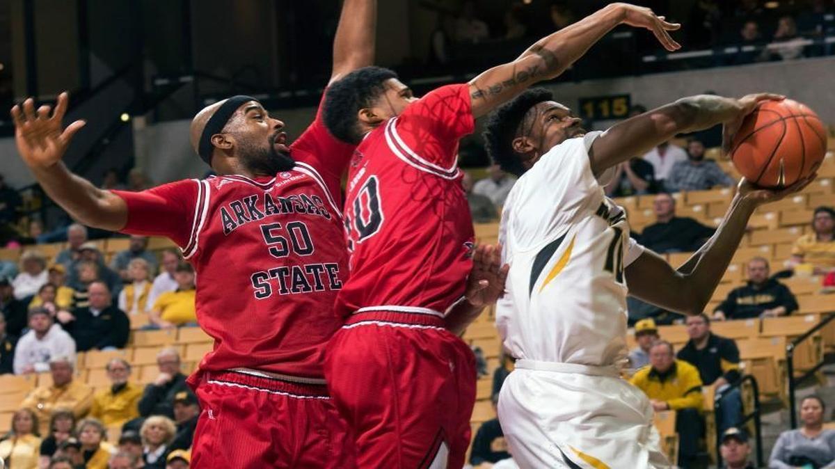 Missouri’s K.J. Walton (right) pulled down a rebound in front of Arkansas State’s Frederic Dure (center) and Anthony Livingston in the first half Tuesday night in Columbia.