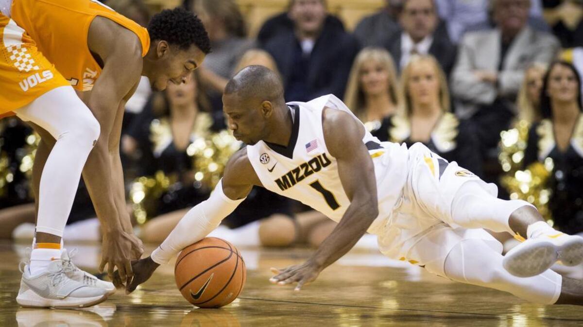 Tennessee Volunteers guard Jalen Johnson (13) tried to scoop the ball as Missouri Tigers guard Terrence Phillips (1) hit the floor during the first half of the Tigers’ win on Jan. 17 at Mizzou Arena.