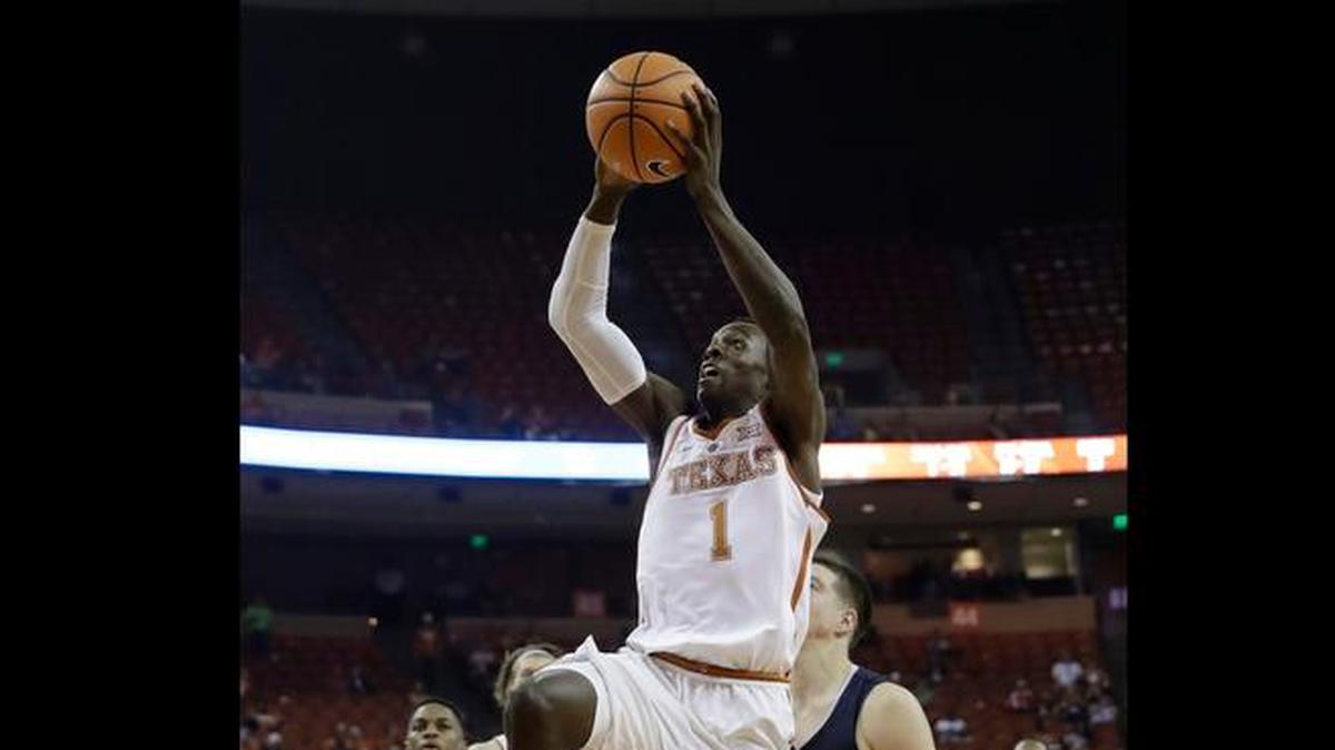 Texas guard Andrew Jones (1) drives to the basket past New Hampshire forward Tanner Leissner (21) during the second half of an NCAA college basketball game, Tuesday, Nov. 14, 2017, in Austin, Texas. Texas won 78-60.