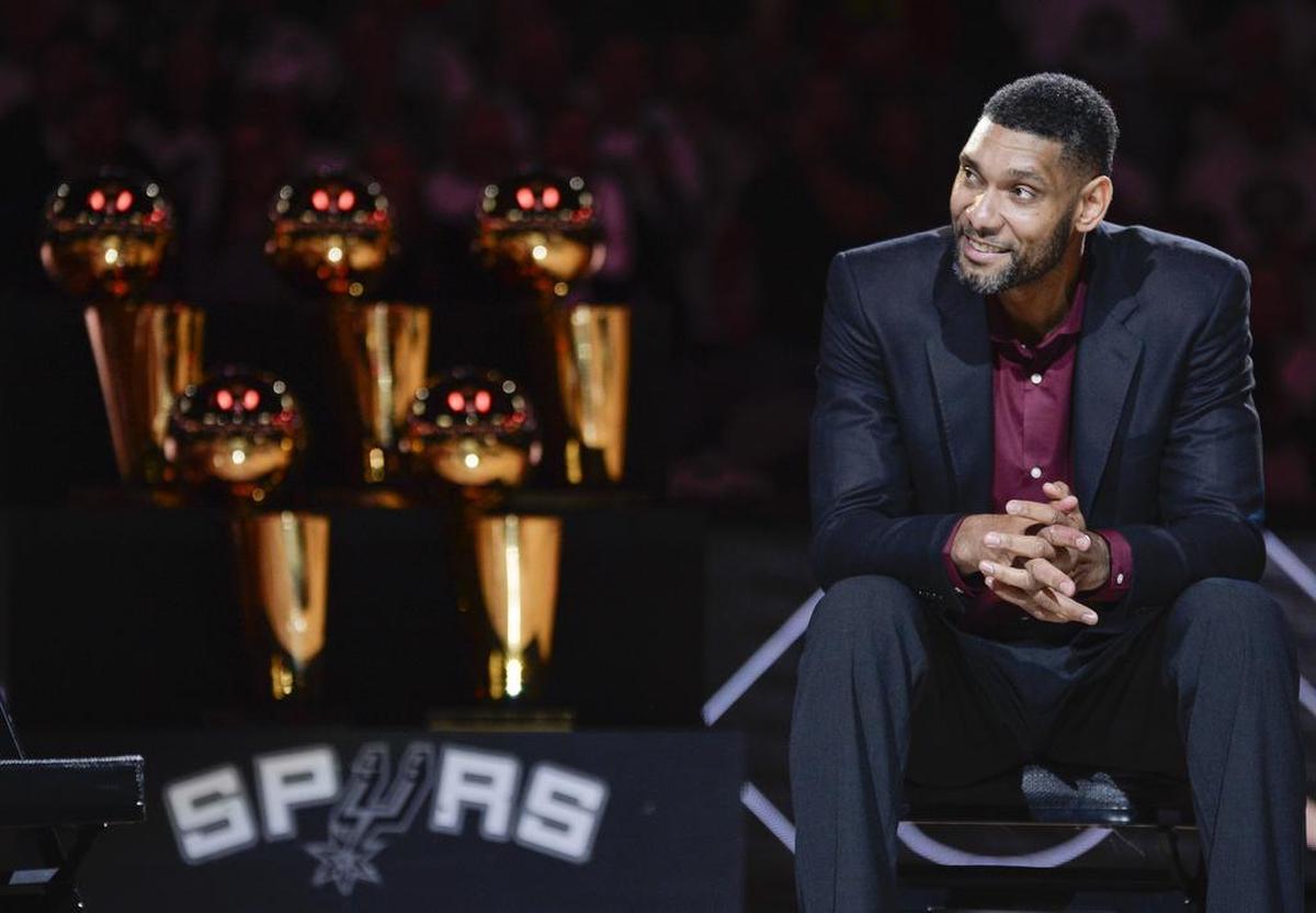 FILE - In this Dec. 18, 2016, file photo, San Antonio Spurs’ Tim Duncan listens while special guests speak about him during his jersey retirement ceremony in San Antonio. Wake Forest star Tim Duncan, Gonzaga’s John Stockton and Duke standout Jay Williams headline the class that will be inducted into the National Collegiate Basketball Hall of Fame on Sunday