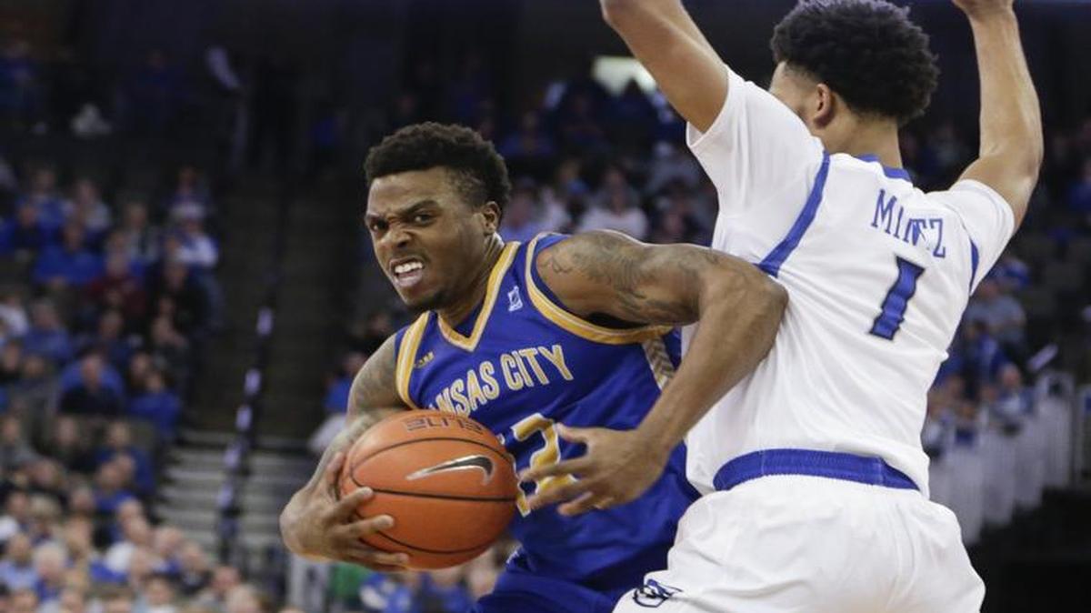 UMKC guard Martez Harrison (left) tried to work his way around Creighton guard Davion Mintz during the second half of their game in Omaha, Neb., on Friday.