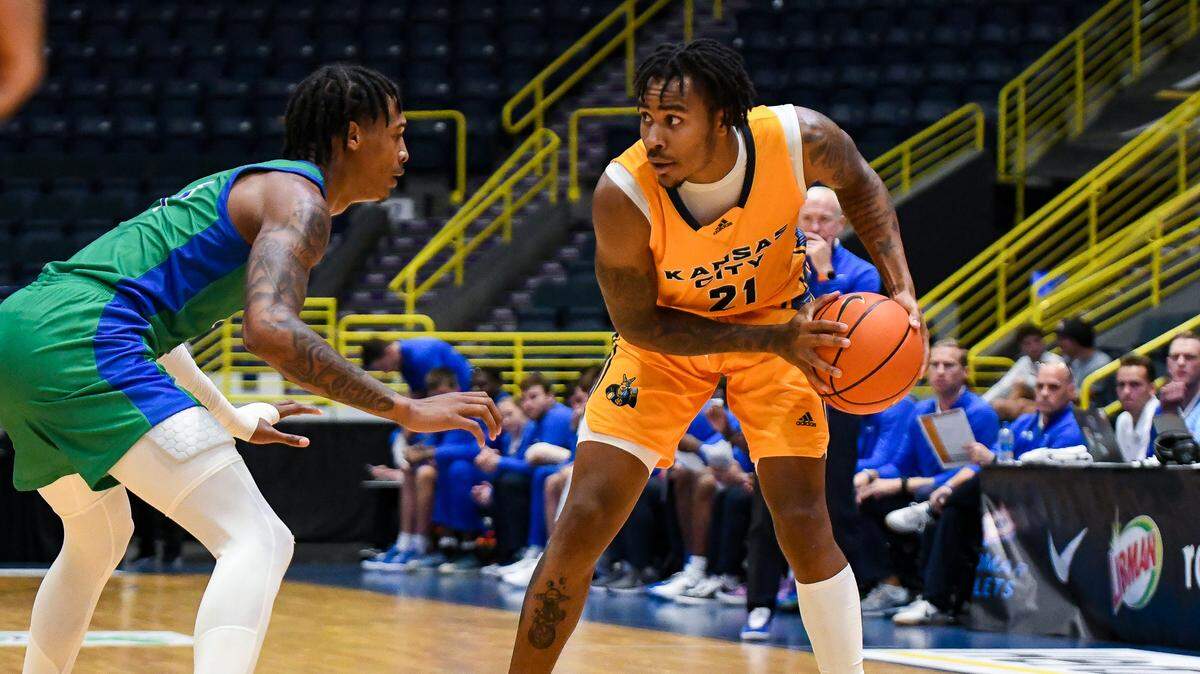 Kansas City Roos guard RayQuawndis Mitchell holds the ball away from a Florida Gulf Coast defender at the Gulf Coast Showcase. KC fell despite 29 points from Mitchell on Wednesday, Nov. 23, 2022.