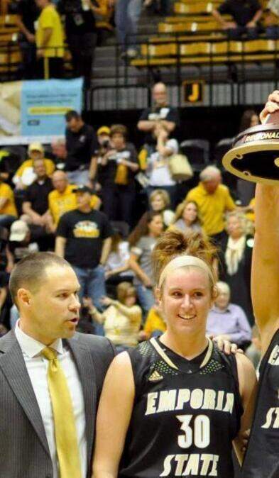 
Merissa Quick held up the NCAA Central Regional championship trophy alongside teammate Kathryn Flott and coach Jory Collins.
