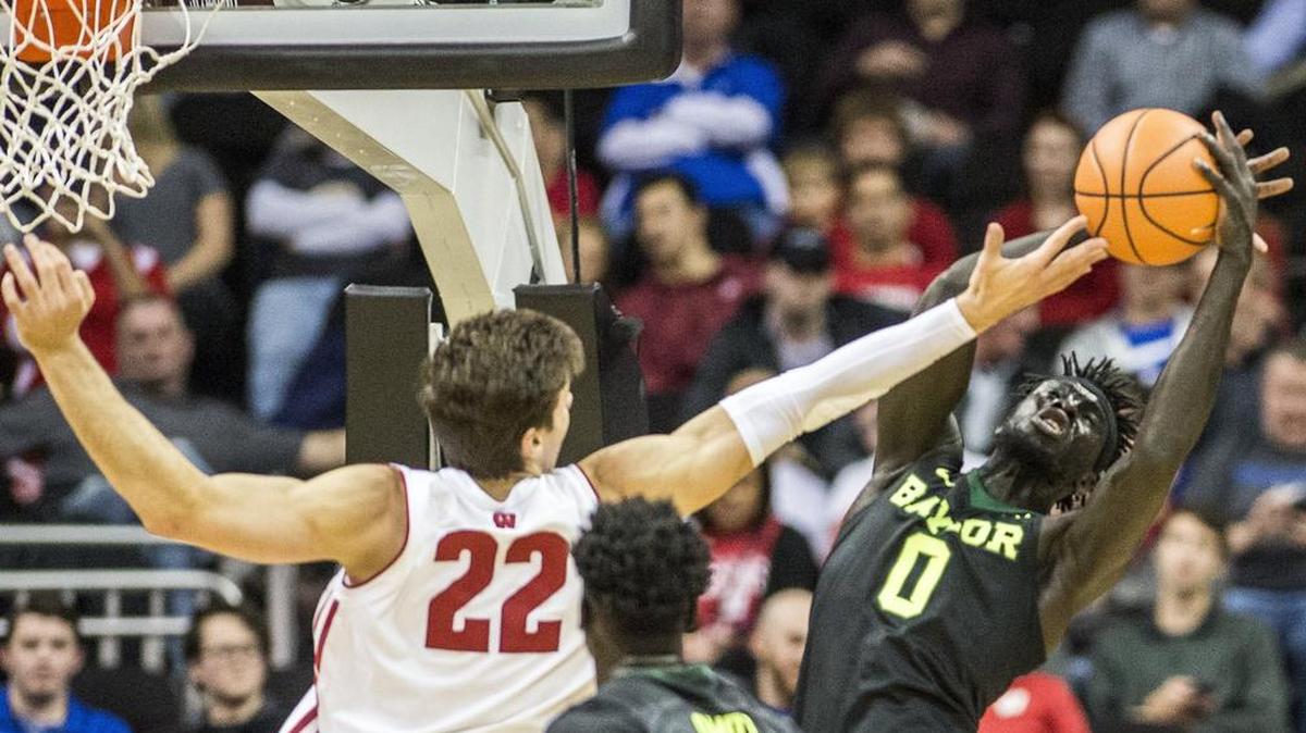 Baylor forward Jo Lual-Acuil Jr. (right) grabbed a rebound away from Wisconsin forward Ethan Happ in the first half of Monday’s Hall of Fame Classic semifinal game at the Sprint Center.