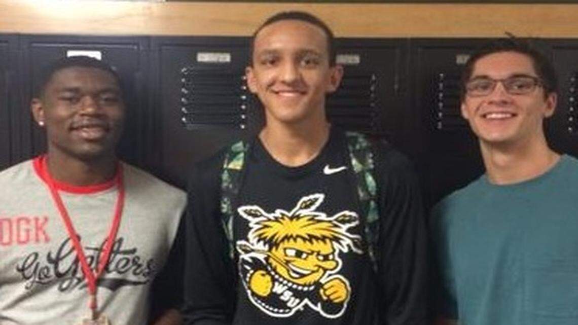 
Landry Shamet, center, stands with Park Hill students after committing to Wichita State.
