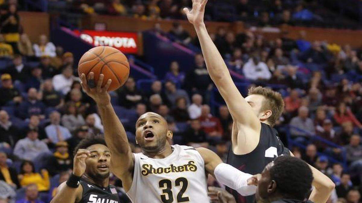 
Wichita State guard Tekele Cotton split a group of Southern Illinois defenders during the first half of their Missouri Valley Tournament quarterfinal Friday at the Scottrade Center in St. Louis.
